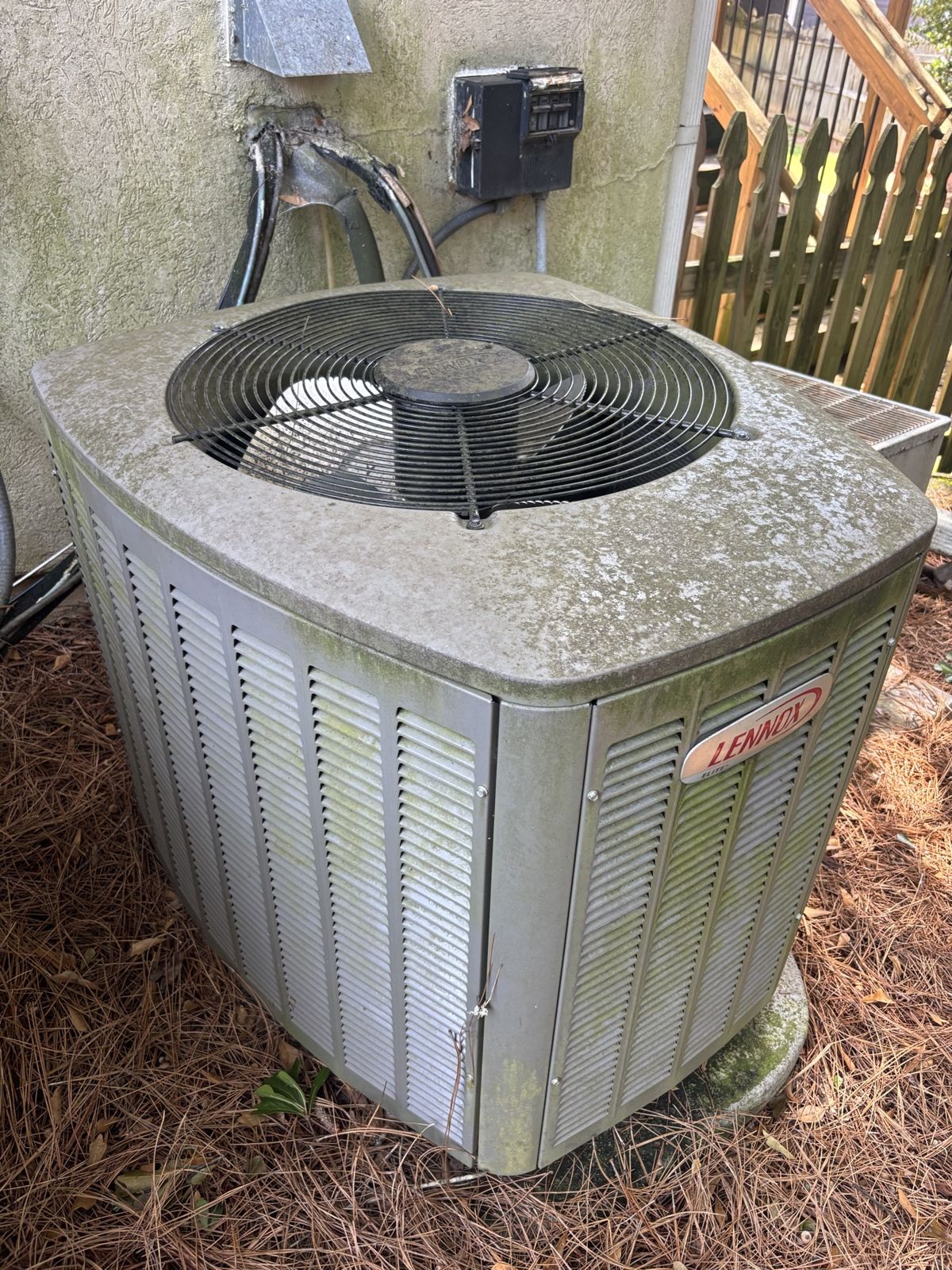 New outdoor AC condenser installed by Southeast in a customer's side yard