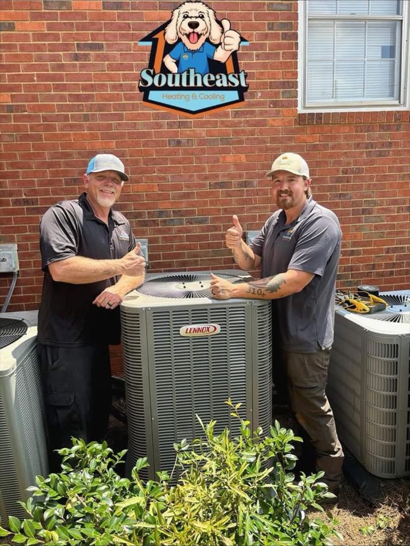 Southeast technicians beside two condensers